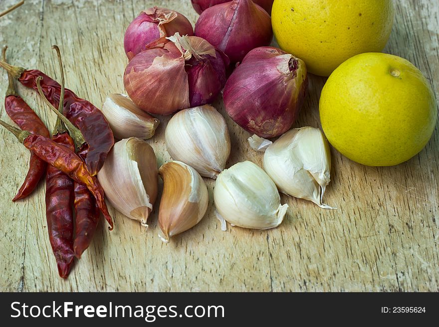 Onion, garlic, lemon pepper on a cutting board.