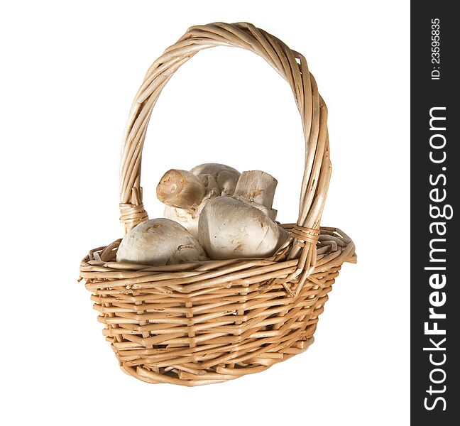 Mushroom champignon in the basket isolated on white background