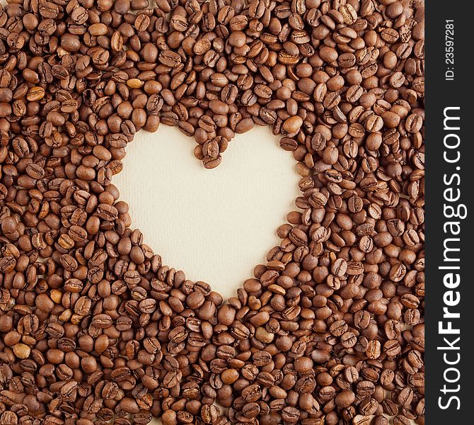 A heart symbol made from coffee crops on hand-made paper