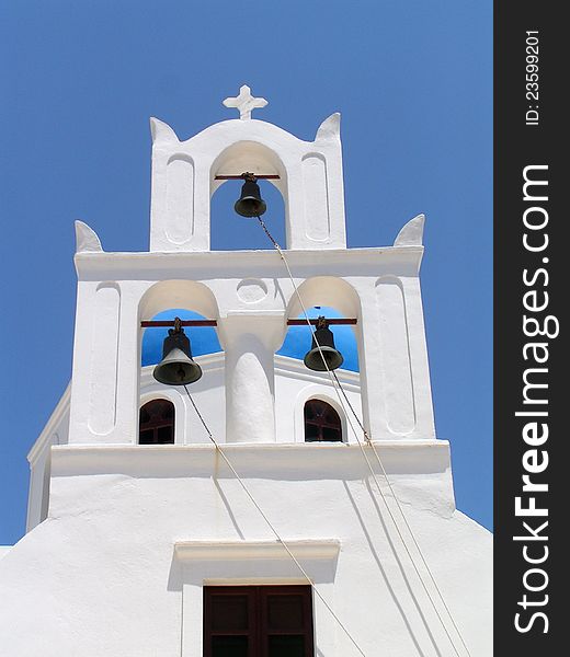 Taken on the Greek island of Santorini, show typical white church building against the blue sky. Taken on the Greek island of Santorini, show typical white church building against the blue sky.