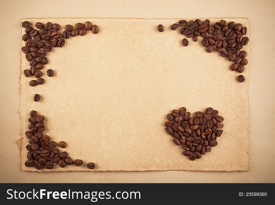 A frame and a heart symbol made from coffee crops on hand-made paper, plenty of place for text