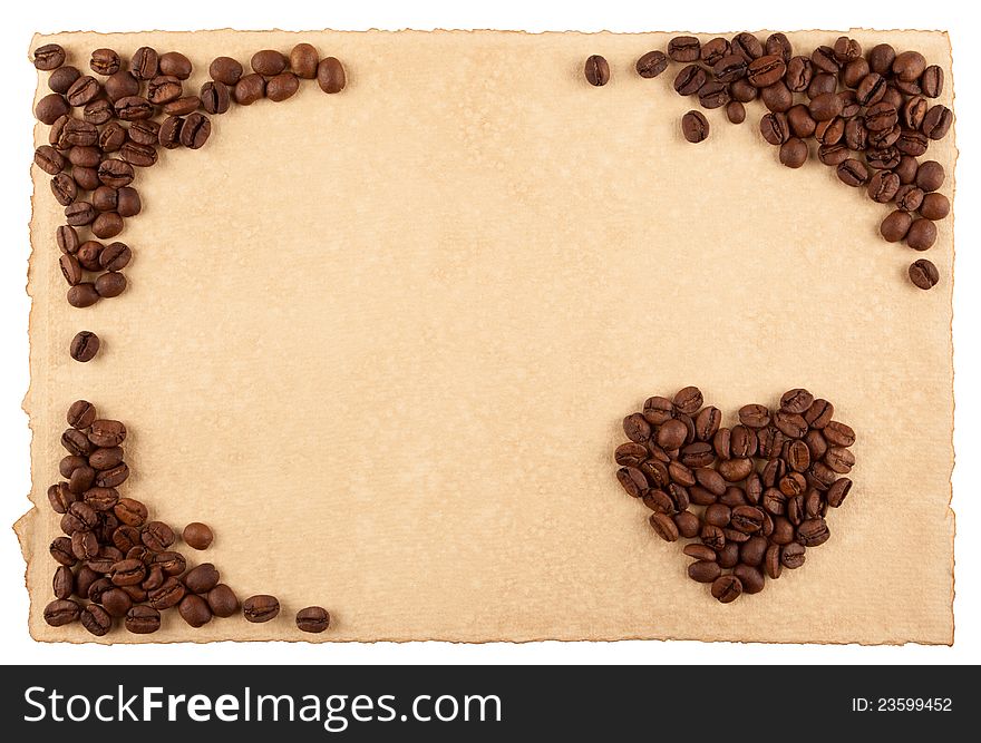 A frame and a heart symbol made from coffee crops on hand-made paper and isolated on white. Place for text.