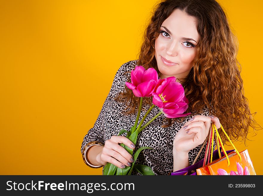 Beautiful woman with flowers and bags long fibers