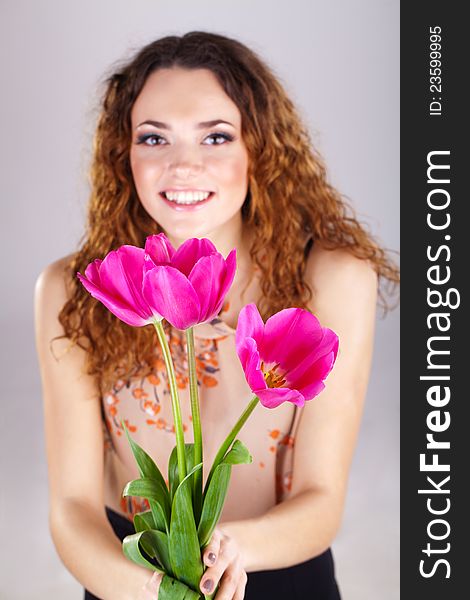Beautiful woman with flowers in studio. Beautiful woman with flowers in studio