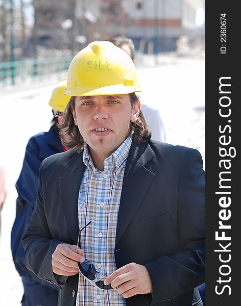 Boss wearing yellow helmet on a construction site. Boss wearing yellow helmet on a construction site