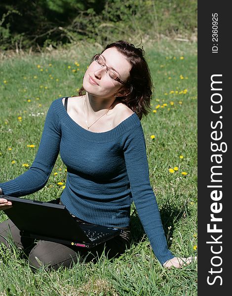 Beauty woman work with notebook in a grass. Beauty woman work with notebook in a grass