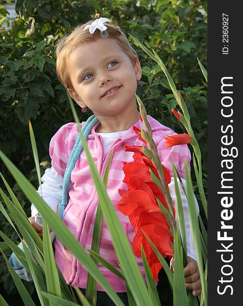 Little girl with flower in summer day