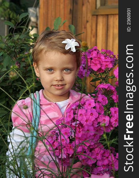 Little girl with flower in summer day