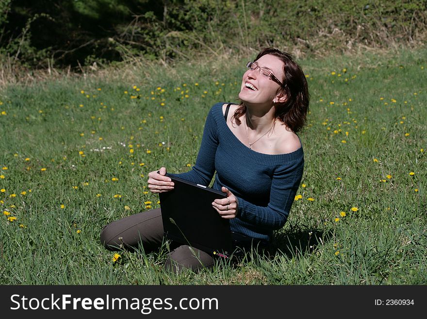 Beauty woman work with notebook in a grass. Beauty woman work with notebook in a grass