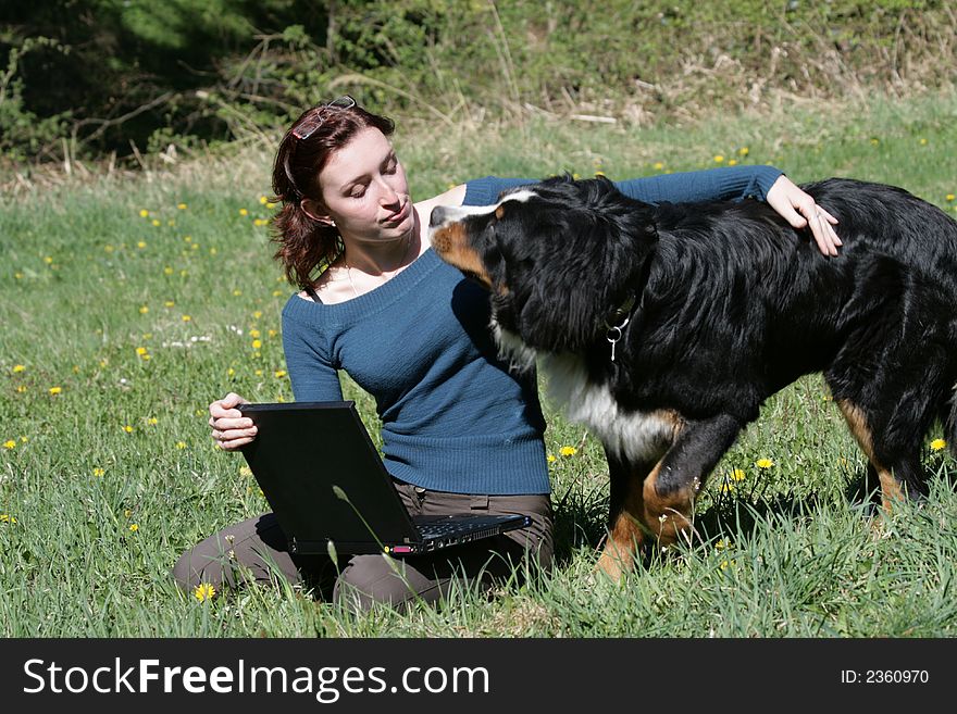 Beauty woman work with notebook in a grass. Beauty woman work with notebook in a grass