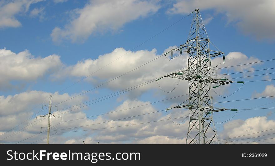 High-voltage columns on a background of the cloudy sky