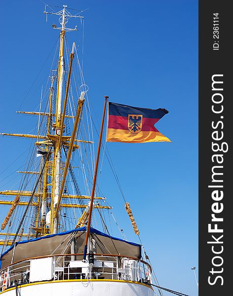 German flag on sailing ship at harbor