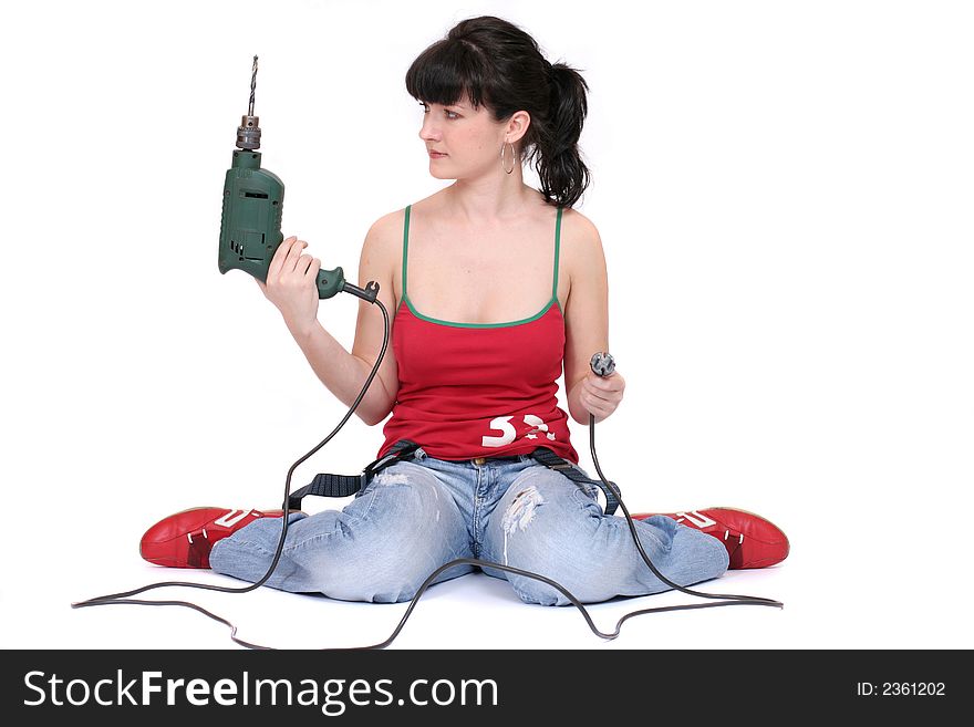 Woman sitting with a drill on the floor. isolated. Woman sitting with a drill on the floor. isolated
