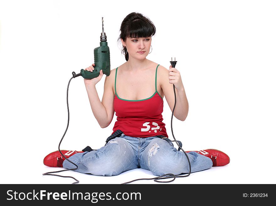 A woman sits and looks at the drill's flex with incomprehension. White background. A woman sits and looks at the drill's flex with incomprehension. White background.