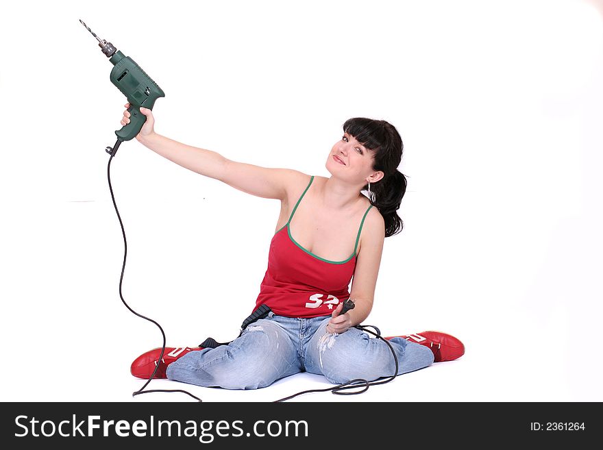 A woman holds a lifted drill. White background. A woman holds a lifted drill. White background.