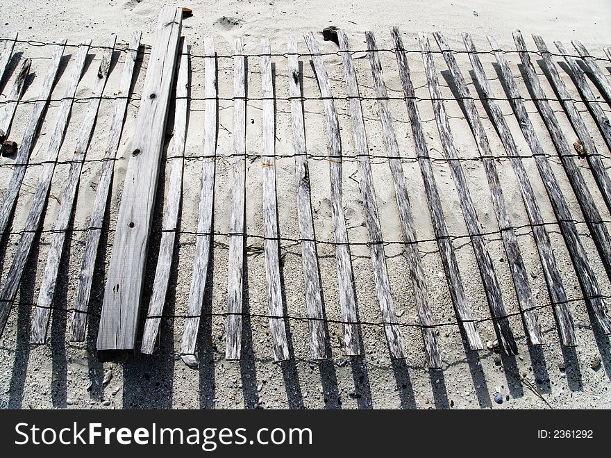 A heavily weathered sand fence lies on its side on a Daytona Beach dune. A heavily weathered sand fence lies on its side on a Daytona Beach dune