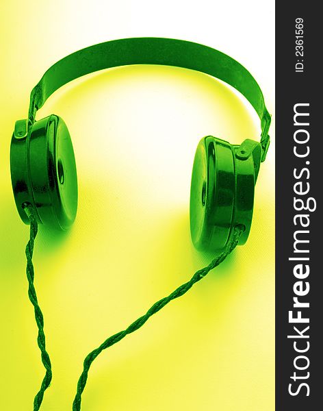 Old headphones on  green background