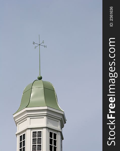 Green dome on a cupola against blue sky