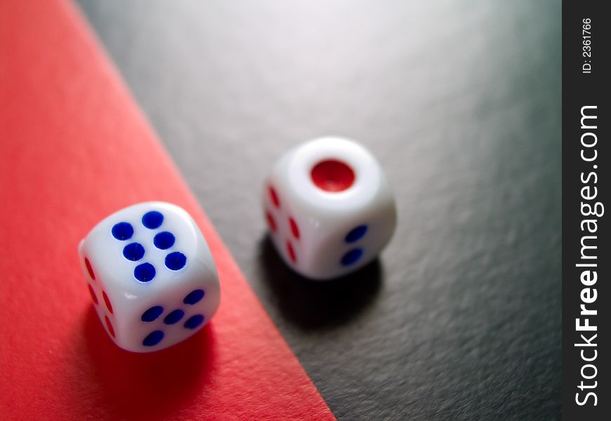 Two dices; red 1 on black background and blue 6 on red background. Two dices; red 1 on black background and blue 6 on red background
