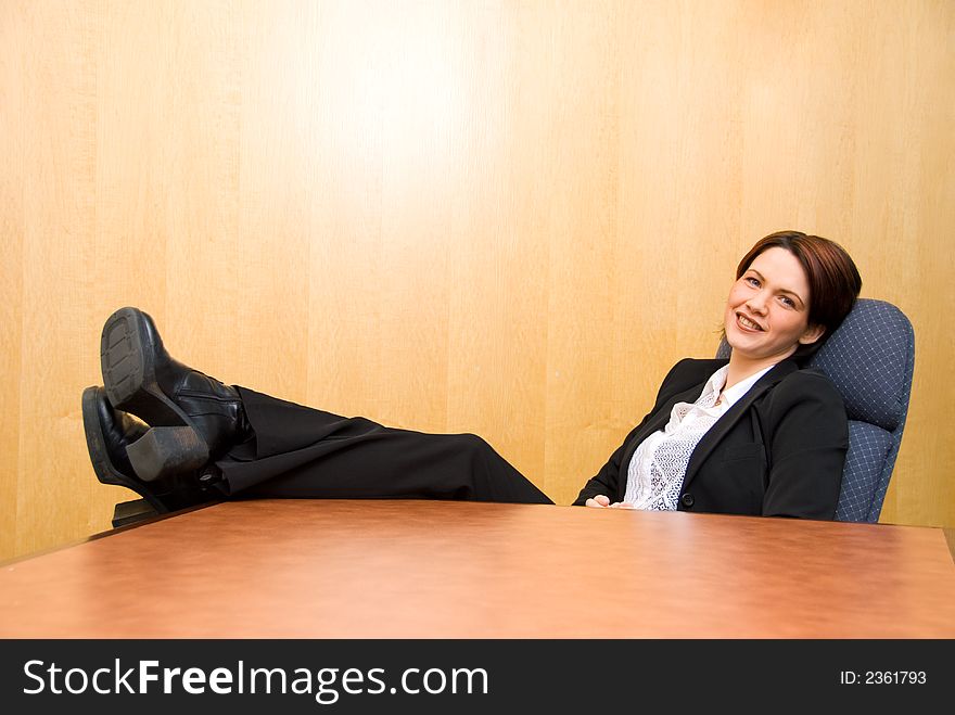 Business woman with her feet up on the table. Business woman with her feet up on the table