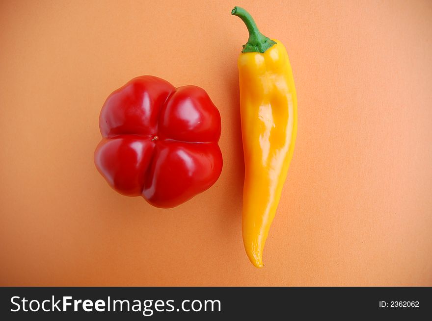 Red and yellow pepper on orange, healthy diet, vegetables