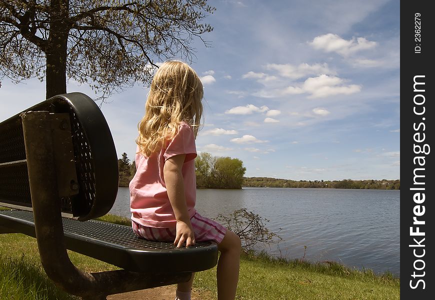 Girl Sitting By Lake