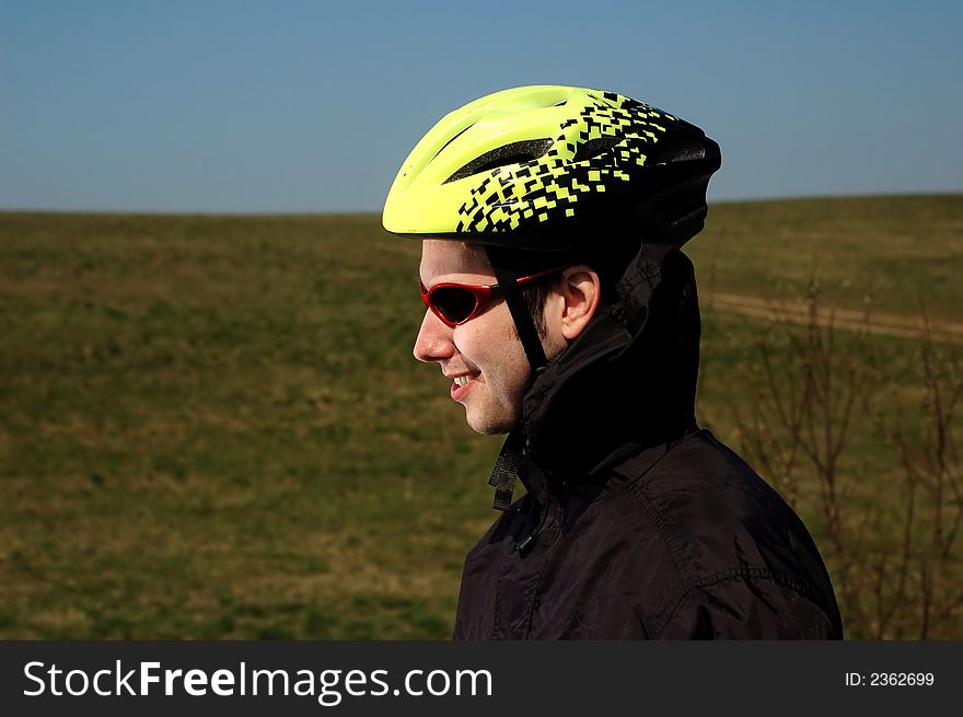 Photo of mountain biker in sporting costume with helmet. Photo of mountain biker in sporting costume with helmet.