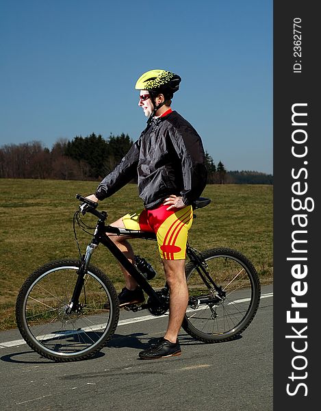 Photo of mountain biker in sporting costume with helmet. Photo of mountain biker in sporting costume with helmet.