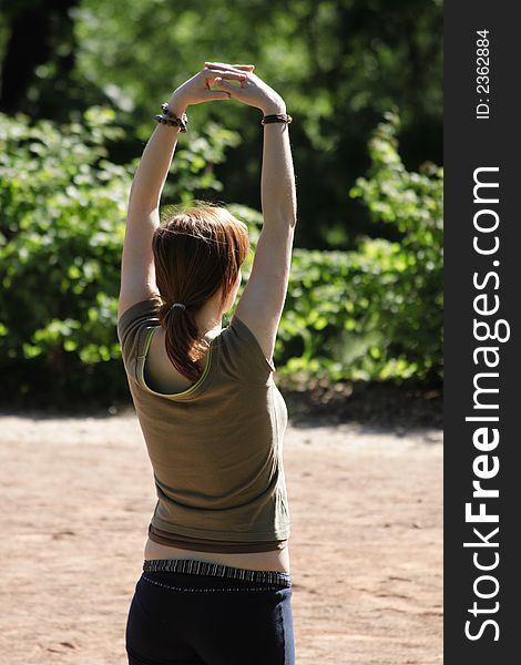 A woman practises thaj ti chuan in a park