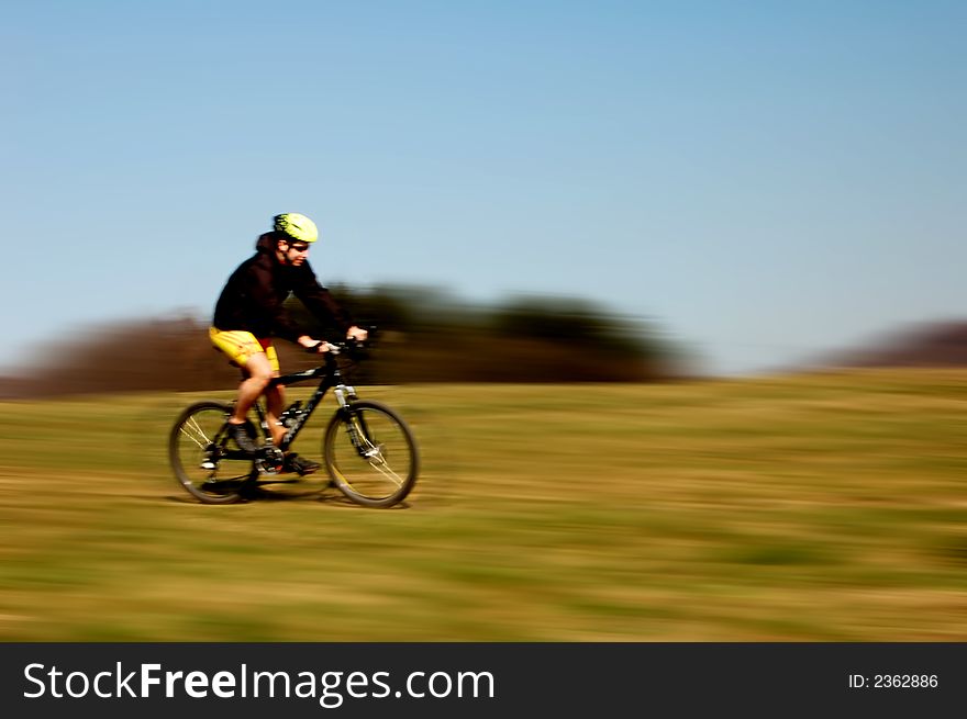 Photo of mountain biker in sporting costume with helmet. Photo of mountain biker in sporting costume with helmet.