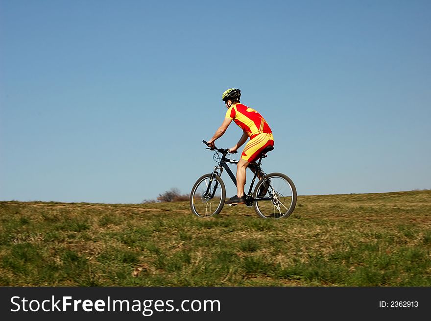 Photo of mountain biker in sporting costume with helmet. Photo of mountain biker in sporting costume with helmet.