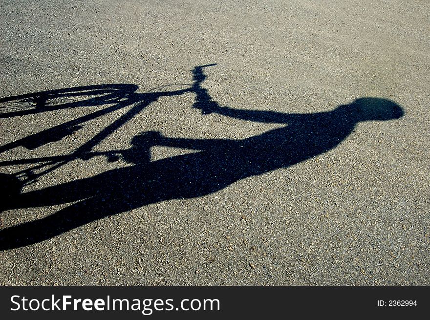 Photo of shadow of a biker. Photo of shadow of a biker.