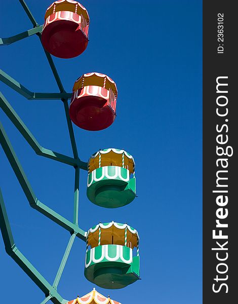 A multi-colored ferris wheel against a clear blue sky

<a href=http://www.dreamstime.com/search.php?srh_field=play&s_ph=y&s_il=y&s_sm=all&s_cf=1&s_st=wpo&s_catid=&s_cliid=301111&s_colid=&memorize_search=0&s_exc=&s_sp=&s_sl1=y&s_sl2=y&s_sl3=y&s_sl4=y&s_sl5=y&s_rsf=0&s_rst=7&s_clc=y&s_clm=y&s_orp=y&s_ors=y&s_orl=y&s_orw=y&x=43&y=5> See more playfull pictures </a>