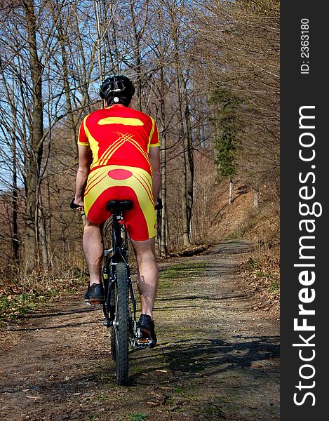 Photo of mountain biker in sporting costume with helmet. Photo of mountain biker in sporting costume with helmet.