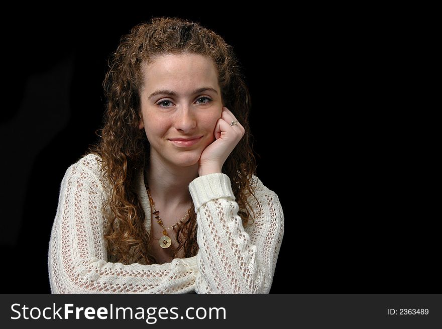 Teen girl portrait looking at the camera against black background