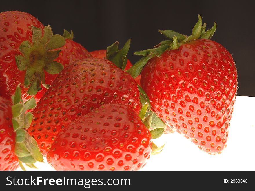 Red strawberries with black background. Red strawberries with black background