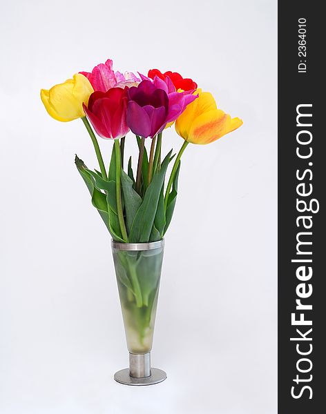 Glass vase with bunch of tulips in it. Glass vase with bunch of tulips in it