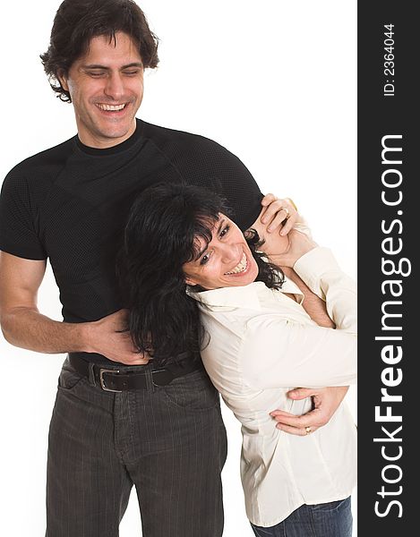 Portrait of happy couple cuddling over white background