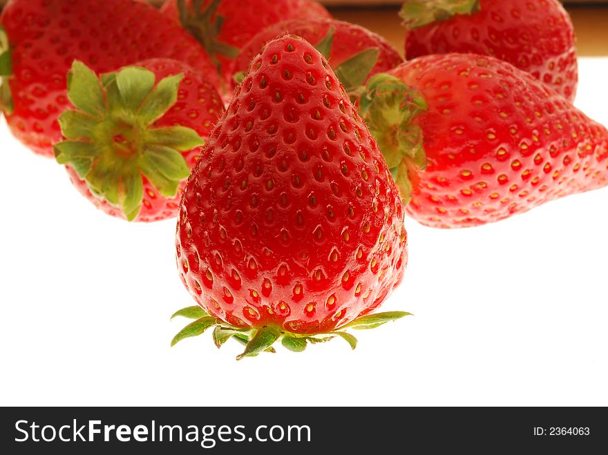 Red and fresh strawberries on white background