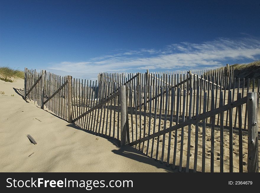 Weathered fence on beach guiding visitors to water. Weathered fence on beach guiding visitors to water