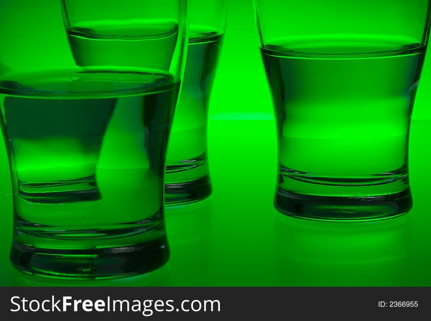 Liquid filled glasses with green backlighting. Liquid filled glasses with green backlighting.