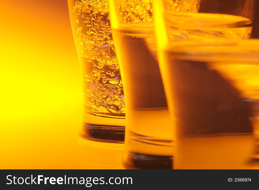 Liquid filled glasses with yellow back lighting.