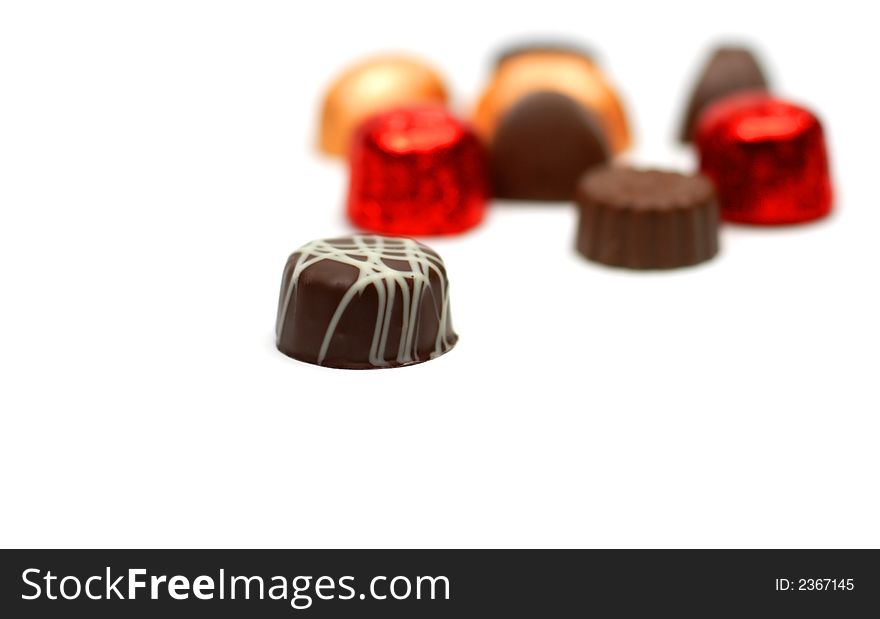 Fancy tasty chocolates over white background with selective focus. Fancy tasty chocolates over white background with selective focus.