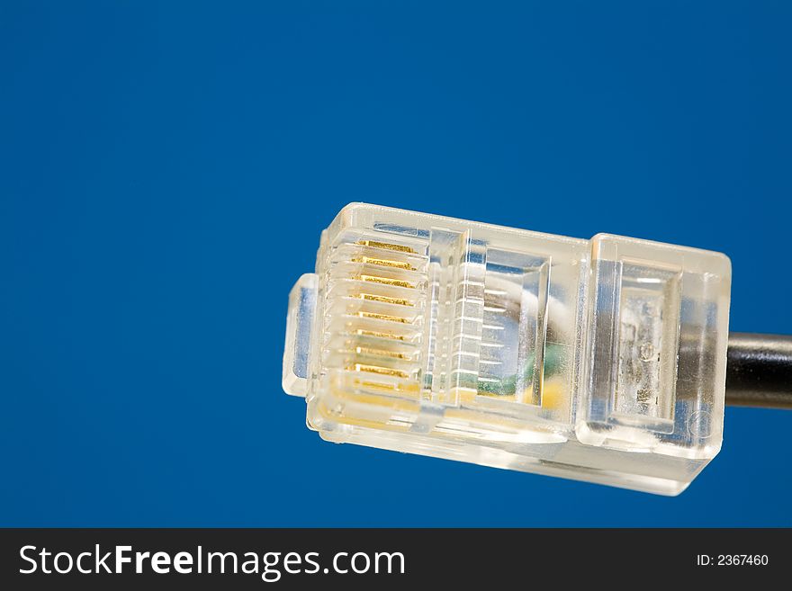 Single RJ45-Plug. Close-Up, blue background. Copyspace. Single RJ45-Plug. Close-Up, blue background. Copyspace.