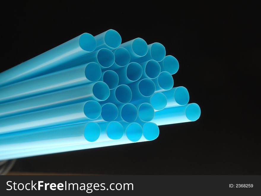 Blue drinking straw with black background