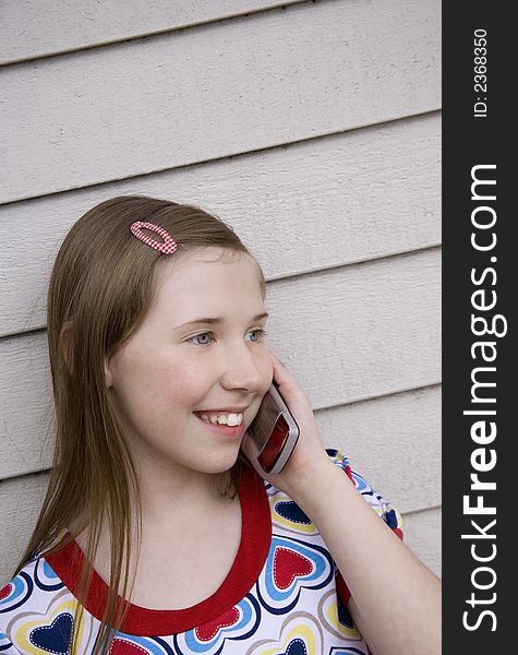 Image of a preteen girl on her cell phone. Image of a preteen girl on her cell phone