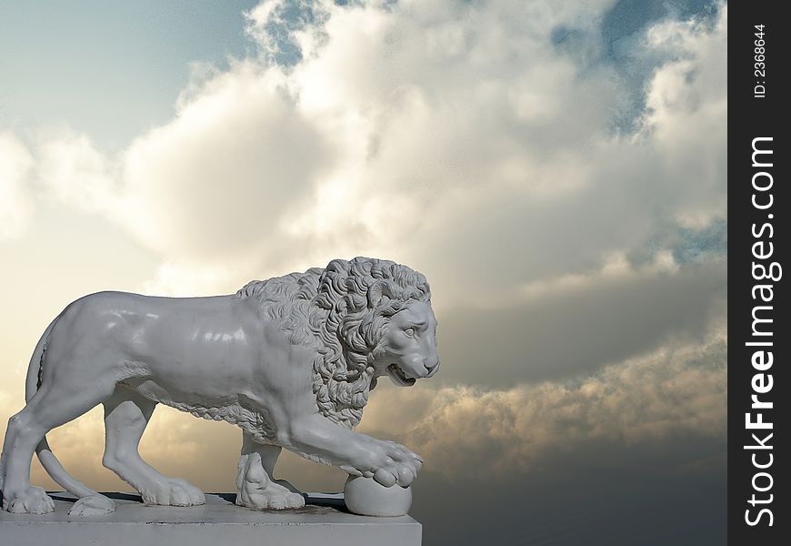 Sculpture of a white lion on a background of the sunset sky