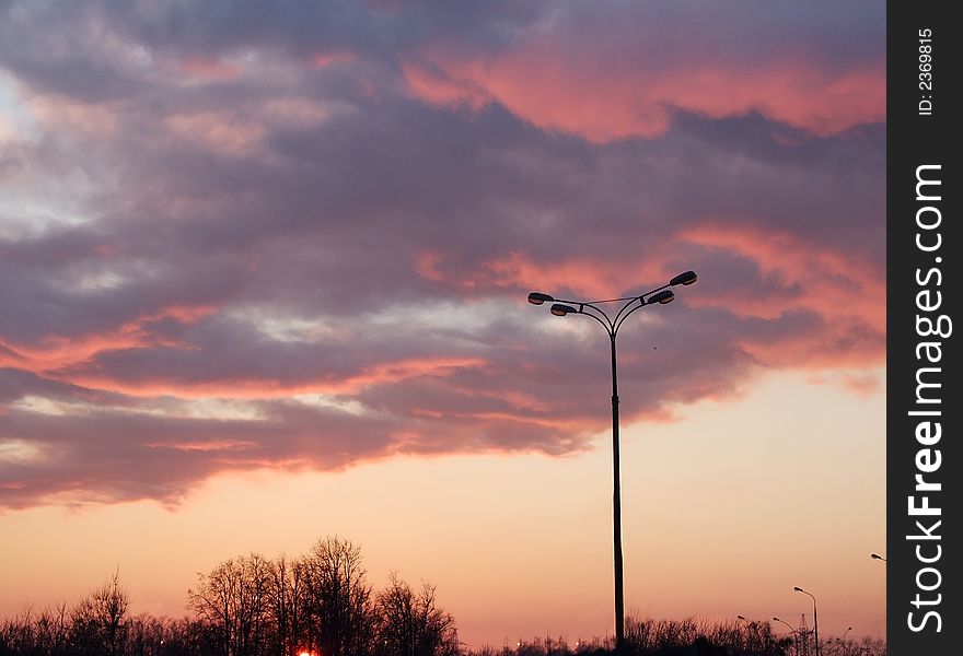 Colorful sunrise and lamppost, clouds