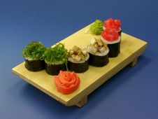 Delicious Sushi Rolls On Wooden Plate Royalty Free Stock Photos