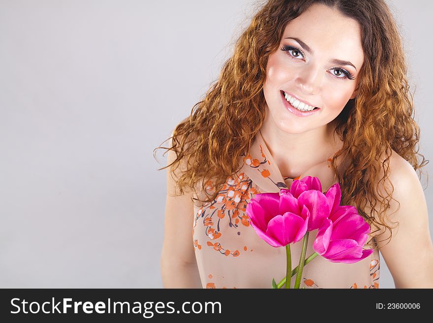 Beautiful woman with flowers in studio. Beautiful woman with flowers in studio